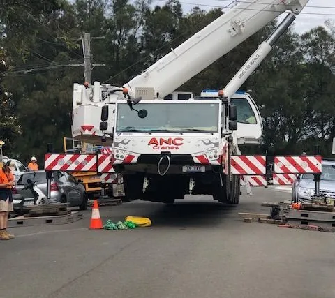 Crane truck and traffic control on a street for an urgent tree job
